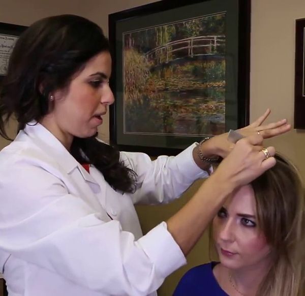 Doctor examining patient's scalp